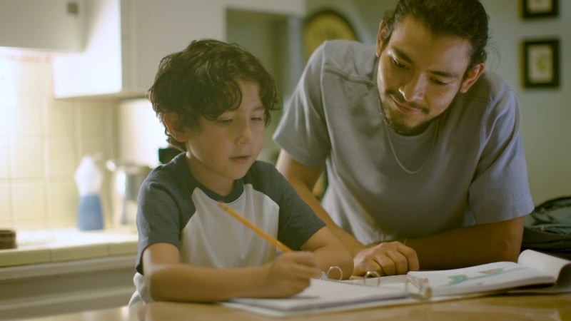 A man helping a child with homework