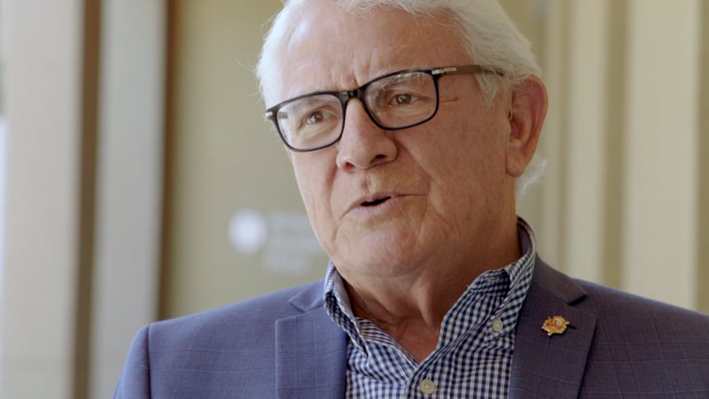 A man with glasses and a suit jacket.