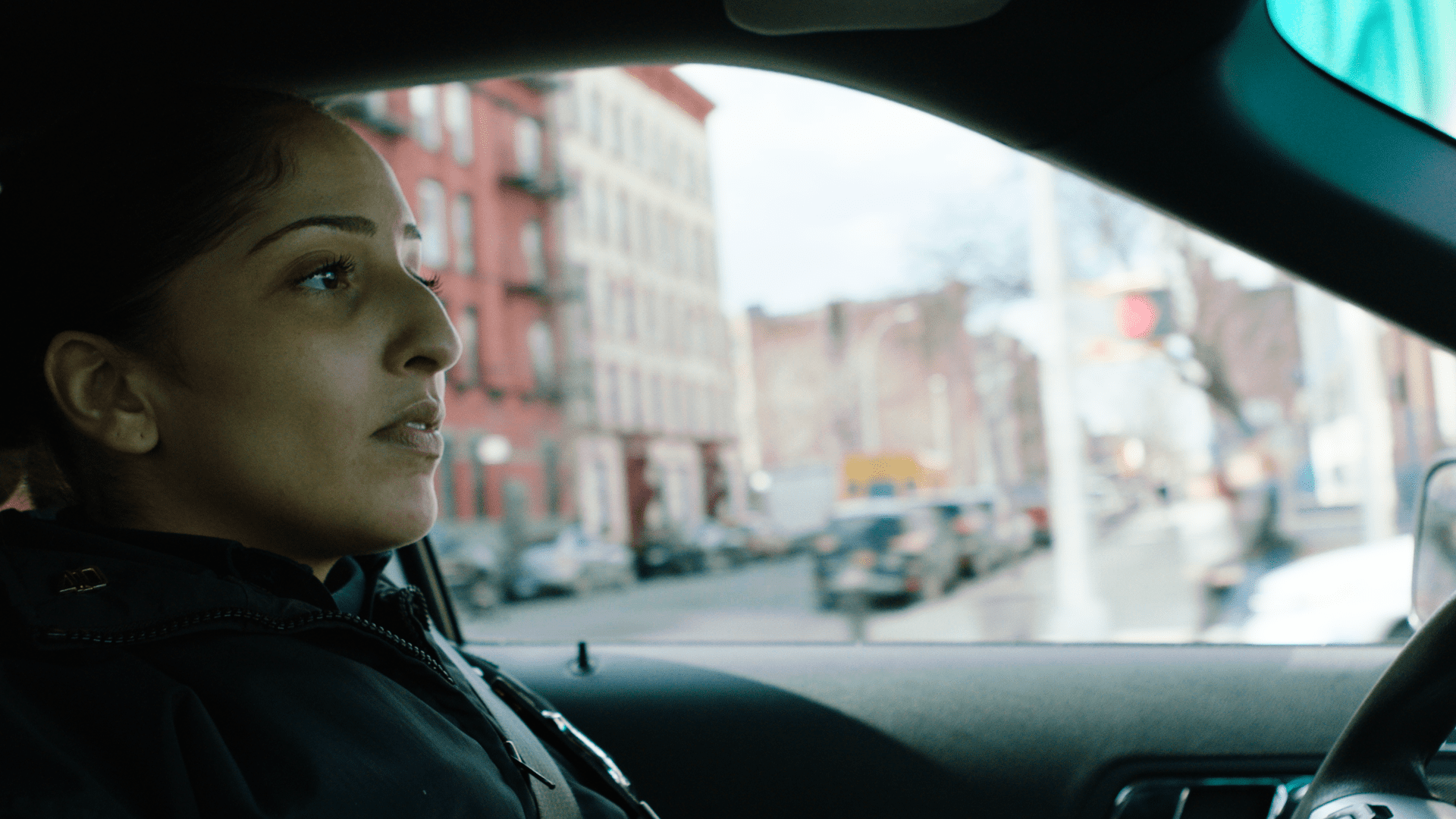 A woman sitting in the driver 's seat of a car.