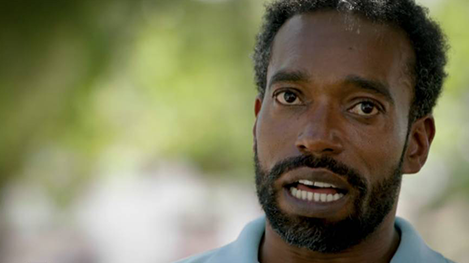 A man with a beard and mustache looking at the camera.